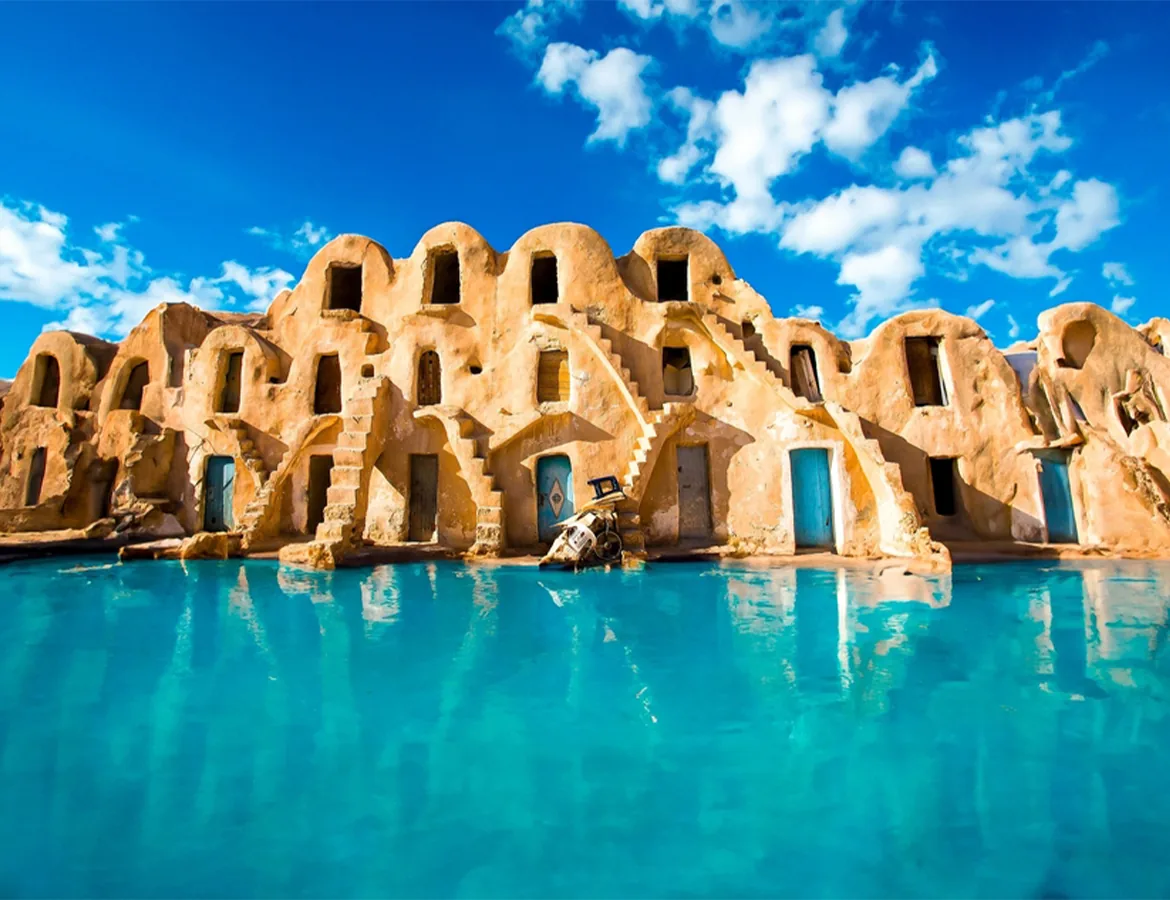 A traditional ksar granary of the Tunisian south reflected in turquoise water